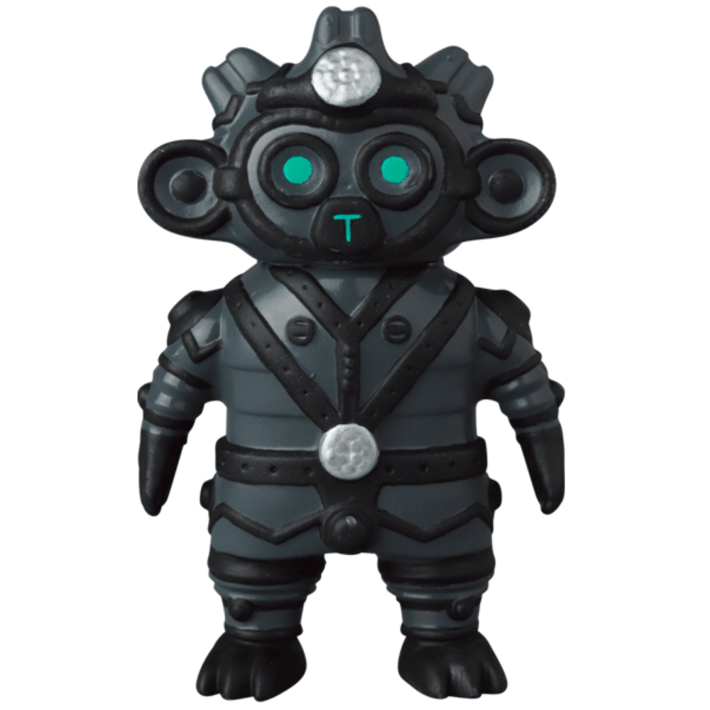 The VAG 34 - Tomodachi Second Machine by Medicom (JP) is a small black and gray robot figurine with green glowing eyes, round ears, and a metallic helmet with circular details, evoking the image of an ancient machine on a white background.