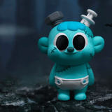 The Villain Baby - Blind Box by Partner Toys features a blue cartoon figure with large black eyes, stitches, a head bolt, and a syringe, dressed in a white diaper and standing on a dark textured surface.