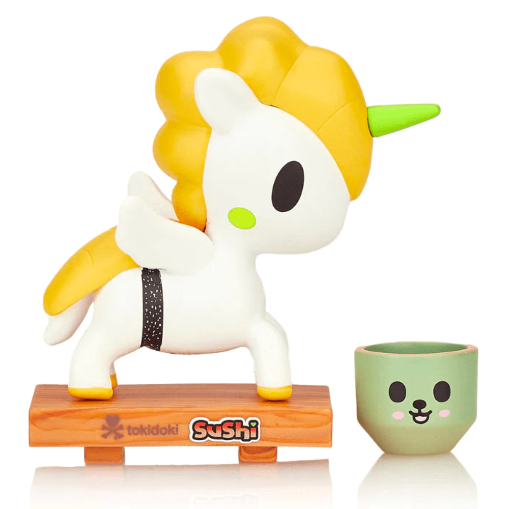 A Tokidoki Sushi Unicorno Blind Box on a wooden base next to a cup.