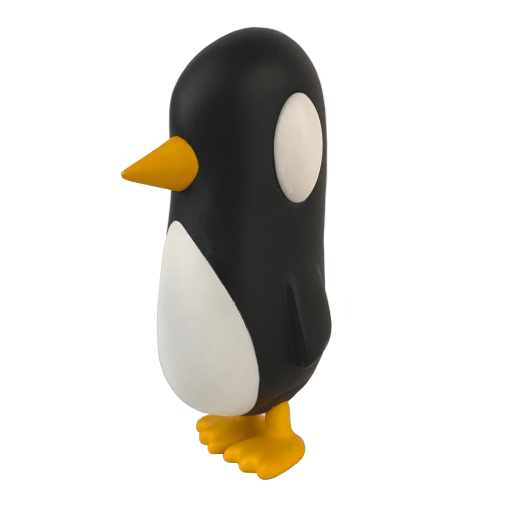 The Old Friend — Original by Strange Cat is a black and white penguin figurine with yellow beak and feet, standing upright against a plain white background, ready to greet you like an old friend.