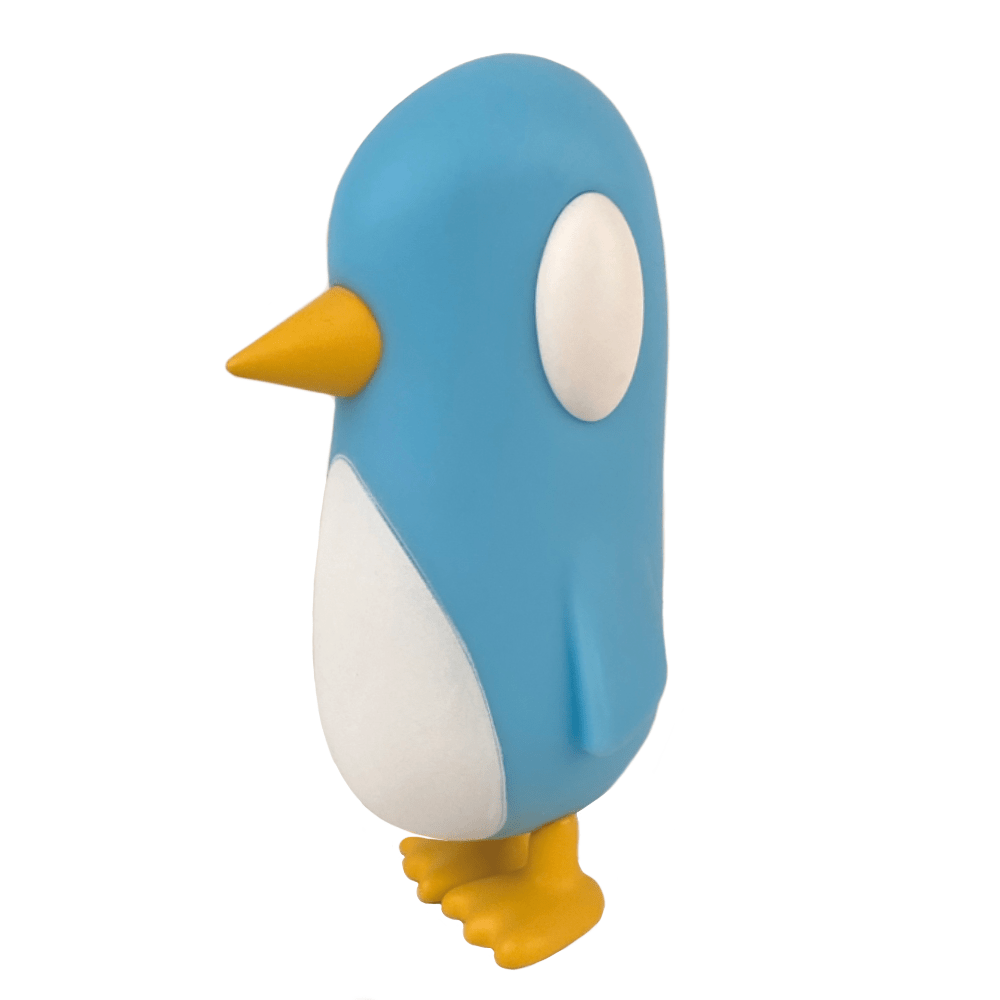 Strange Cat’s Old Friend — Blue Skies is a blue, minimalist penguin figurine with yellow beak and feet, white oval eyes, and a white belly—an ideal gift for catching up with an old friend.