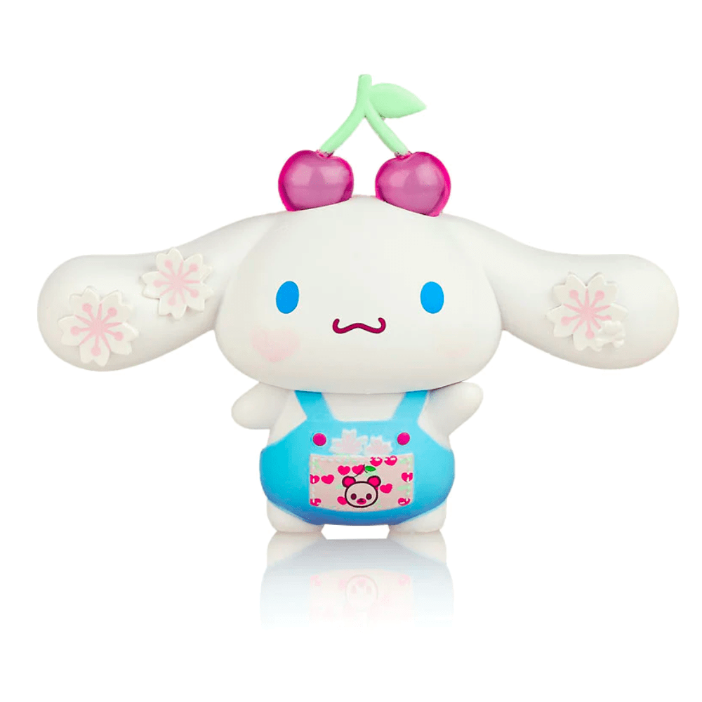 A toy figure from the Hello Kitty X Tokidoki - Series 3 Blind Box, featuring a character with cherry motifs and floral decorations, suitable for Spring, in a blue and pink color scheme.