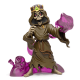 A Kidrobot (US) Dungeons & Dragons - Monster Series 2 Blind Box of a skeleton in a robe holding swirling purple magical energy, wearing a crown and standing next to a smaller ghost figure.