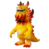 The VAG 10th Anniversary — Rangeas by Medicom (JP) is a yellow and orange monster vinyl toy with horns, sharp teeth, and a spiky back, standing upright—celebrating the playful spirit of Vinyl Artist Gacha collectibles.