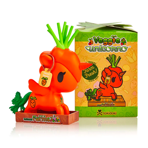 A tokidoki Veggie Unicorno Blind Box vinyl figure, resembling a red tomato with a green stem, presented next to its packaging.