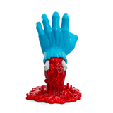 The Kidrobot (US) Screaming Hand 40th Anniv. Glow Art Figure features a blue hand rising from a red, textured base with two white protrusions and glows in the dark—perfect for adding unique flair to your collection.