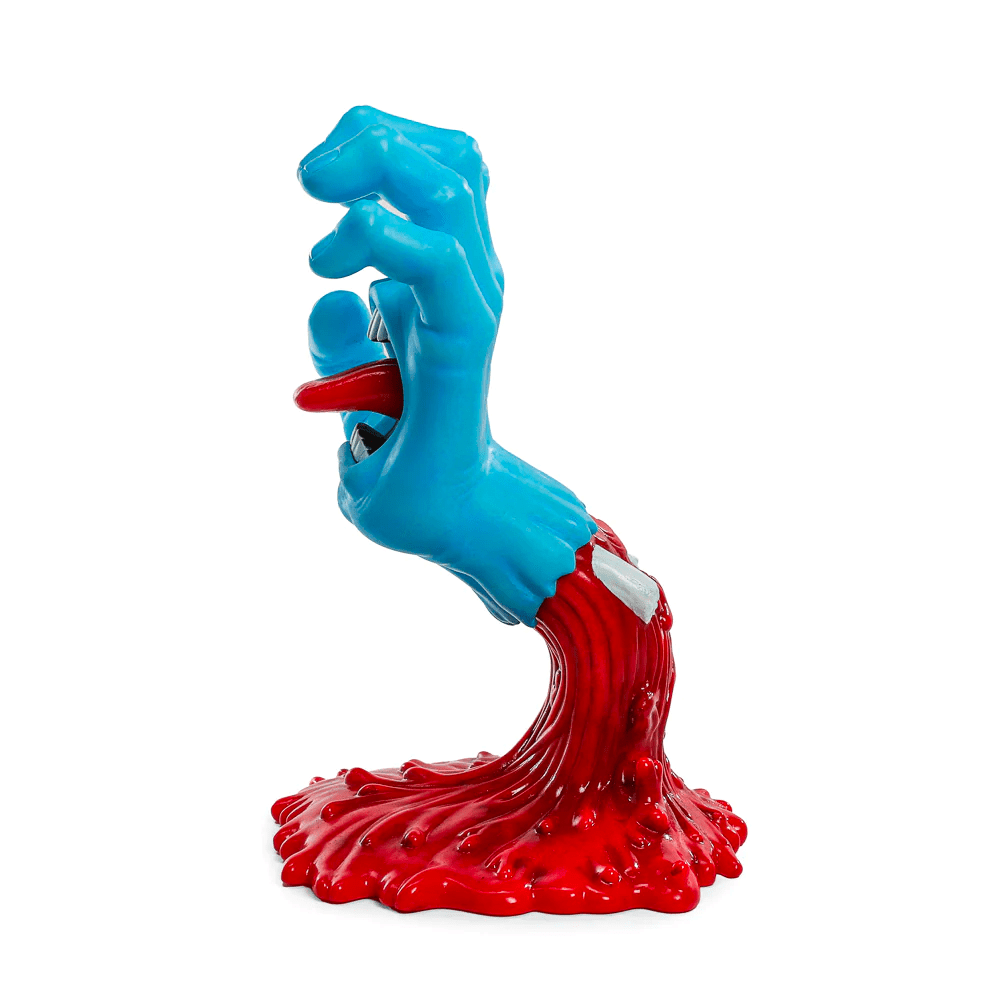 The Kidrobot (US) Screaming Hand 40th Anniv. Glow Art Figure features a blue hand with a mouth and tongue bursting from a red puddle base, all set against white—an eye-catching, glow-in-the-dark collectible.