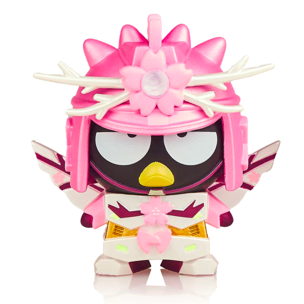 A Hello Kitty X Tokidoki - Series 3 Blind Box figurine, resembling a pink-themed character with bird-like features, adorned with floral accents.