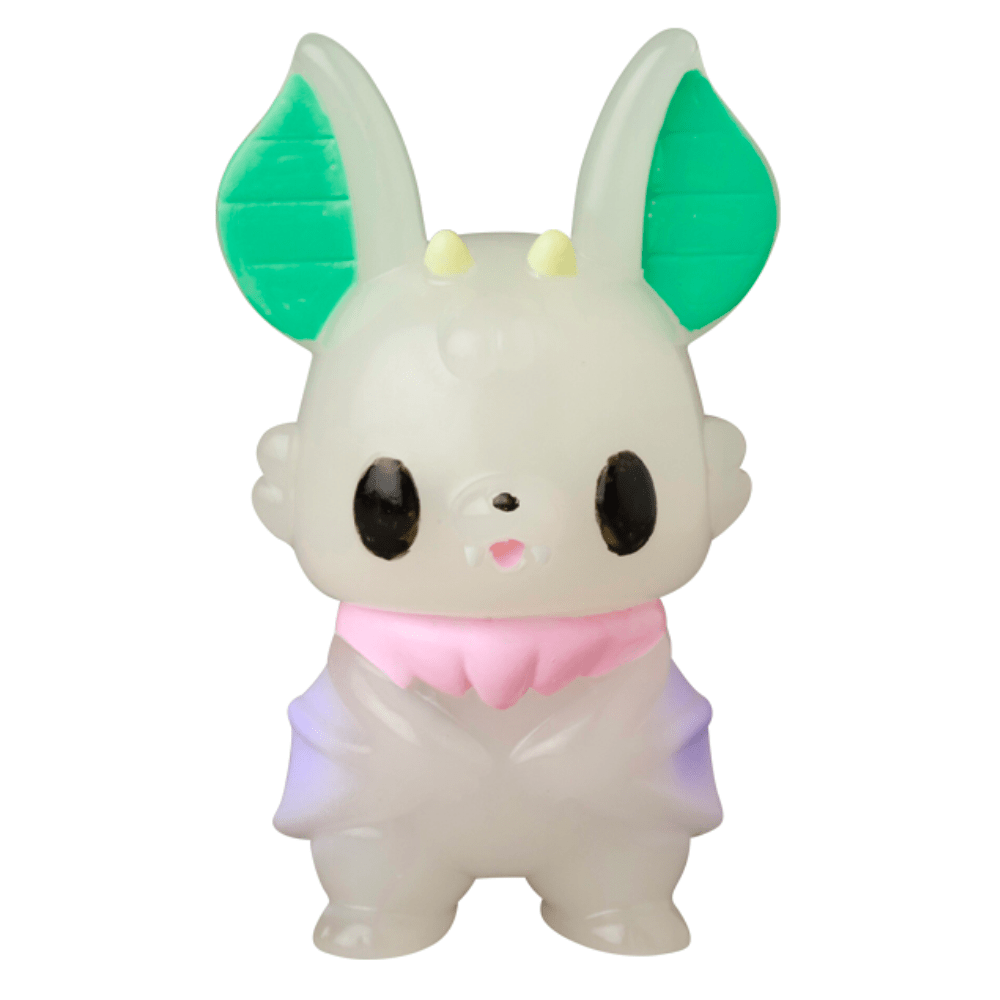 The VAG 10th Anniversary — Kopatapatan by Medicom (JP) is a small, cartoon-like Japanese vinyl toy figure featuring large green ears, black eyes, a pink collar, and a light purple and white body.
