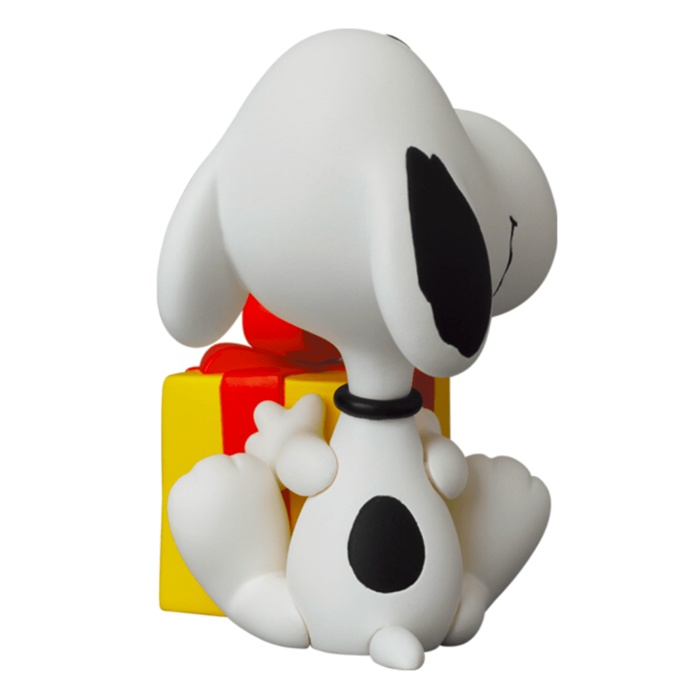 Medicom's Gift Snoopy (UDF Peanuts s15) figurine resting on a yellow and red structure, a perfect gift for any occasion.