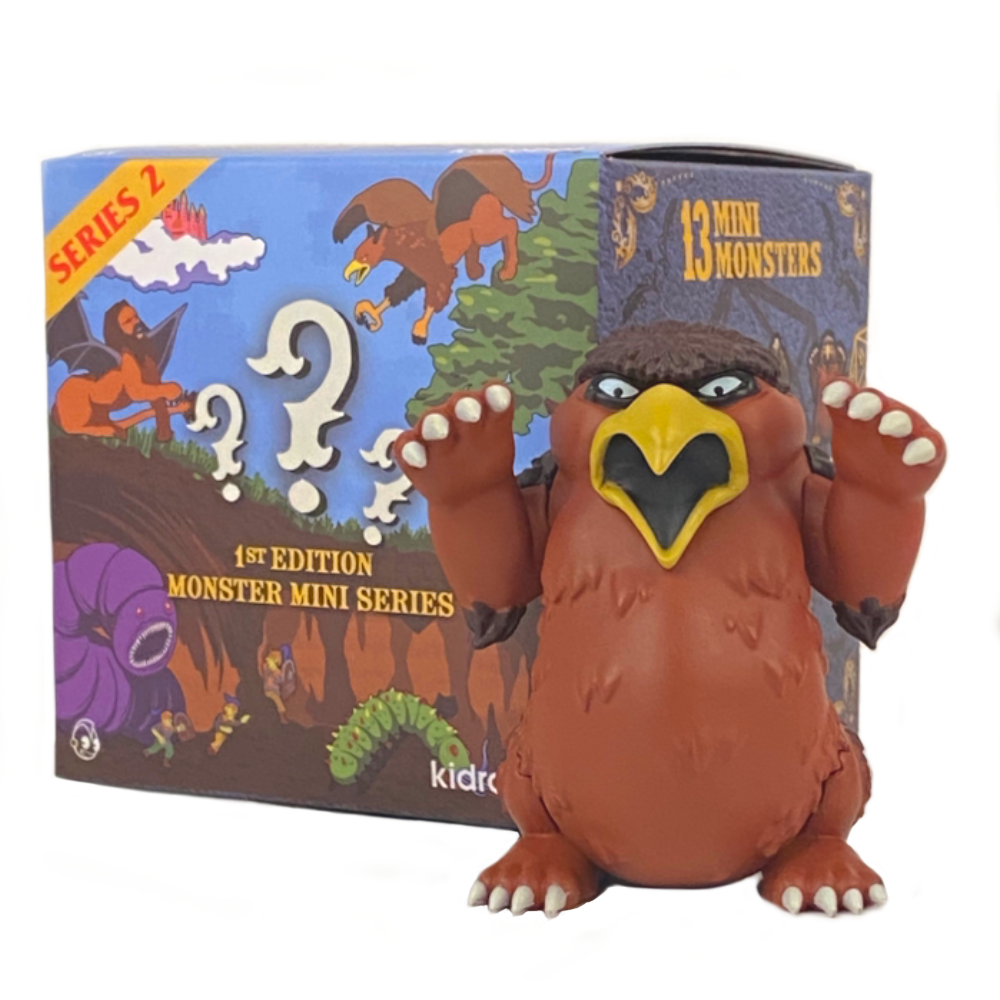 A Dungeons & Dragons monster with an orange body and a bird-like face stands in front of its blind-boxed packaging labeled 