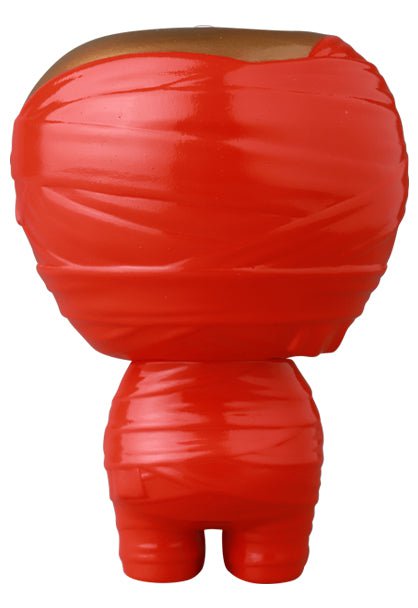 The Medicom (JP) VAG 41 — Yummy Mummy is a red Japanese vinyl toy reminiscent of gachapon figures, wrapped in molded red tape and shown from the back with a round head and short legs.