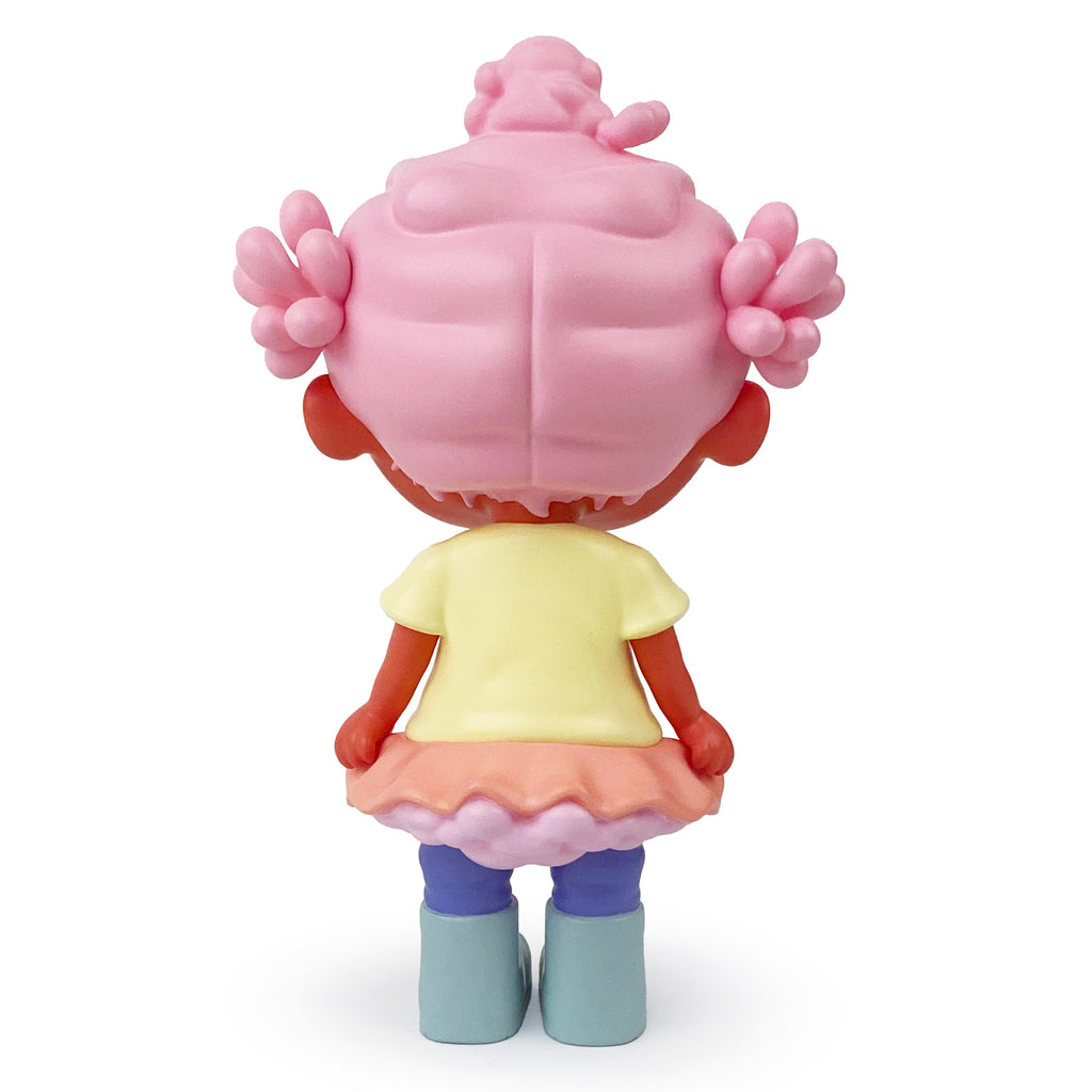 Binky — OG by Rotofugi is a limited edition art toy featuring a Black girl resin figure with pink hair in buns, yellow top, pink/purple skirt, and blue boots, standing with her back to the viewer. Inspired by Bianca Pastel’s vibrant designs.