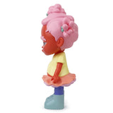 A side view of Binky — OG, a limited edition art toy by Rotofugi, featuring a Black girl resin figure with pink hair in buns, yellow shirt, pink skirt, and light blue boots.
