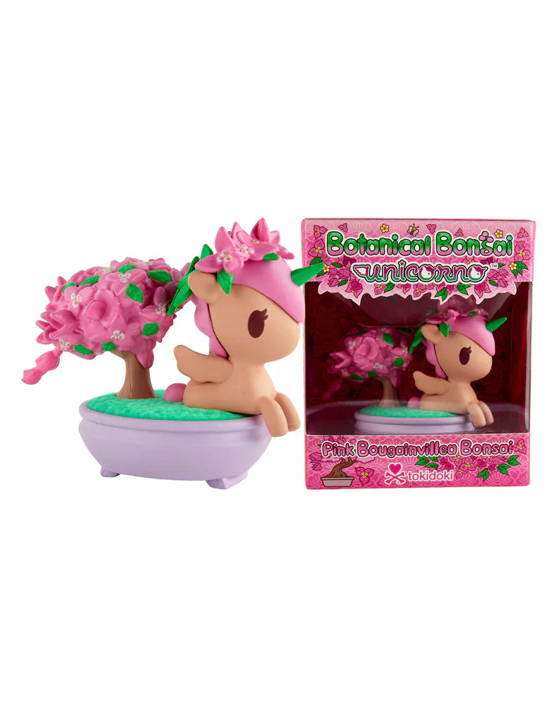 The tokidoki Botanical Bonsai Unicorno - Pink Bougainvillea Bonsai (Special Edition) features a pink Unicorno figurine with a bonsai tree in a purple pot, shown next to its pink floral box and capturing the essence of Pink Bougainvillea.