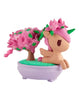 The tokidoki Botanical Bonsai Unicorno - Pink Bougainvillea Bonsai (Special Edition) features a pink unicorn with floral accents beside a blooming pink bougainvillea, set in a purple oval planter with green grass.