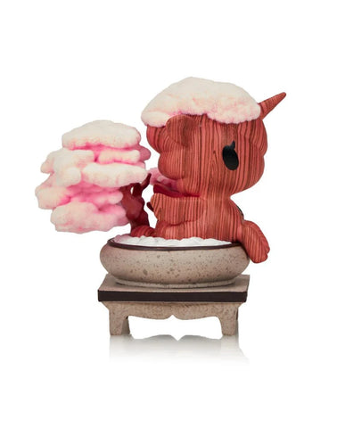 The Tokidoki Botanical Harmony Unicorno - Cherry Blossom Serenity (Special Edition) features a pink-brown figure with tree-like texture and cherry blossom foliage, evoking botanical harmony.