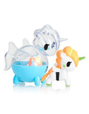 Two vibrant Unicorno Capsule Cuties figures: one featuring an orange mane and a green horn, and the other showcasing transparent details with a blue body. Ideal for tokidoki's Unicorno Blind Box enthusiasts or collectors of Capsule Cuties from Tokidoki.