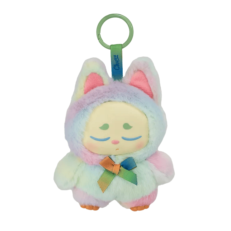 A pastel rainbow plush keychain shaped like a sleepy animal with closed eyes, large ears, and a ribbon around its neck. This magical sprite features a green plastic loop on top for attachment, making it the perfect Kaleidos Creative Chuu Collectible Bag Clip Blind Box accessory.