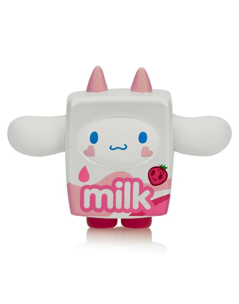 The Tokidoki x Cinnamoroll Sweet Treats Blind Box features a cute milk carton figure with pink horns, feet, wide arms, and a strawberry