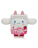 The Tokidoki x Cinnamoroll Sweet Treats Blind Box features a cute milk carton figure with pink horns, feet, wide arms, and a strawberry
