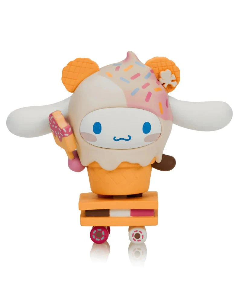 The Tokidoki x Cinnamoroll Sweet Treats Blind Box features a cute Cinnamoroll toy dressed in an ice cream cone with waffle ears, holding an ice cream bar and standing on a skateboard-like base.