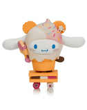 The Tokidoki x Cinnamoroll Sweet Treats Blind Box features a cute Cinnamoroll toy dressed in an ice cream cone with waffle ears, holding an ice cream bar and standing on a skateboard-like base.