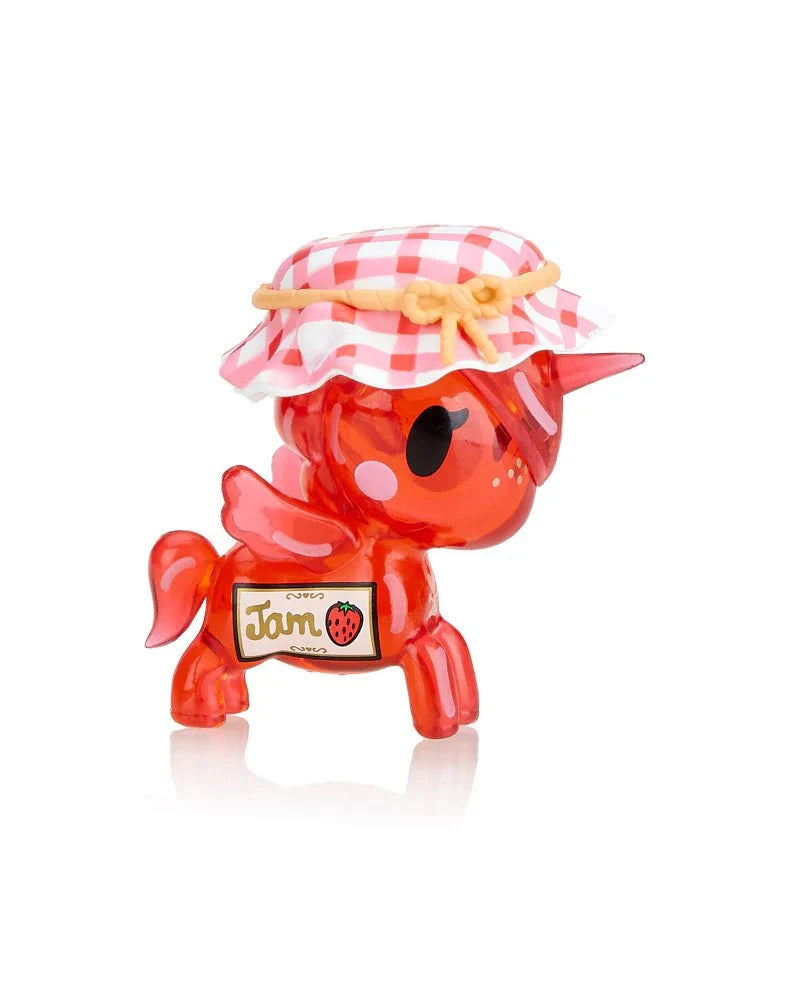 A delightful addition from Tokidoki, this small red Toki Mochi Donut Unicorno Blind Bag figurine features a quirky jar lid hat and a playful