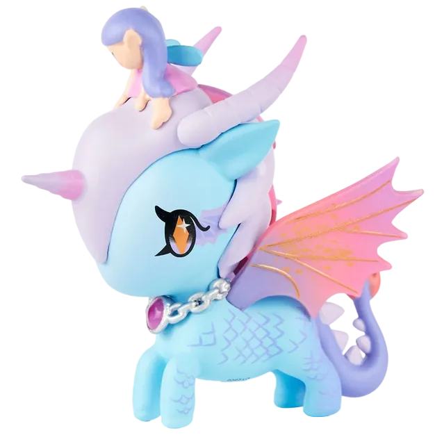 The tokidoki Mystical Dragon Unicorno - Fairy Dragon (Special Edition) features a pastel blue design with pink wings, a silver chain necklace, and a purple gem. Perched on its head is a small figure with purple hair and a pink dress. This special edition toy beautifully combines the enchanting details of a Dragon Fairy with tokidoki’s signature charm.