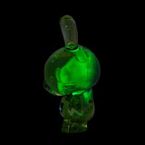 The Kidrobot Infected Specimen Dunny 8” GID Art Figure (LE 600) features a translucent green, rabbit-shaped design with closed eyes and upright ears, displayed on a black background and facing left.