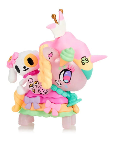 The Tokidoki Harajuku Princess Unicorno - Tanoshii Special Edition by Tokidoki features a pastel-hued unicorn with crown, braided mane, and a white dog with pink bow—perfect for fans of kawaii collectibles.
