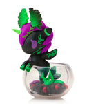 The Tokidoki Neon Reef Mermicorno - Deep Star Coral Special Edition is a small black and purple unicorn figurine with green leafy accents, partly displayed in a clear round container with decorative base—an enchanting collectible.
