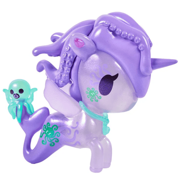The tokidoki Magical Tides Mermicorno features a purple unicorn toy with a mermaid tail, wings, green markings, and tentacle-like hair that embodies ocean-inspired charm and sets off on underwater adventures—complete with a small green octopus figure perched on its tail.