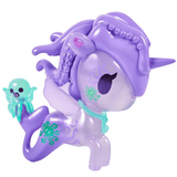 The tokidoki Magical Tides Mermicorno features a purple unicorn toy with a mermaid tail, wings, green markings, and tentacle-like hair that embodies ocean-inspired charm and sets off on underwater adventures—complete with a small green octopus figure perched on its tail.
