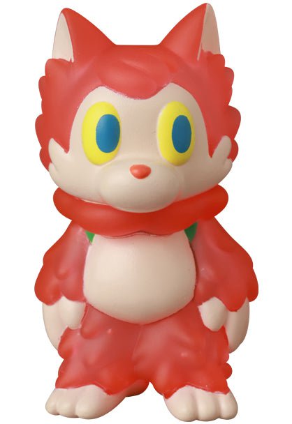 Standing upright, the Medicom (JP) Ookamikun — VAG 10th Anniversary is a red cartoon-style cat figurine with yellow and blue eyes, a white face and belly, and a scarf-like collar, inspired by Japanese vinyl toy design.