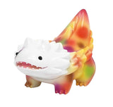 A small, colorful Kaiju toy from The Little Hut (HK), Seedlas Brother — Orange Dots, features a dragon-like shape, white face, spiky details, and a multicolored body with orange dots, photographed on a white background.
