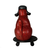 The How 2 Work One-Chu Sk8 - Red Glitter features an 8-inch collectible red glitter dog figure with black ears and helmet, sitting on a matching skateboard, viewed from the back.