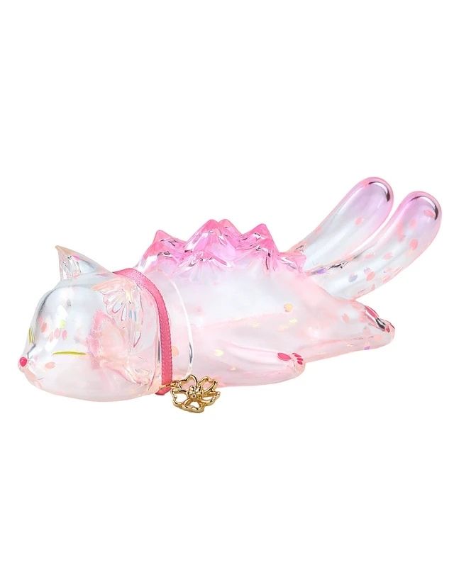 The Sleeping Negora — Falling Sakura by Konatsuya is a glass figurine of a pink, nine-tailed fox with closed eyes, a collar, and gold charm, lying on its stomach in a clear cherry blossom-inspired colorway.