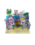 Celebrate 20 years of Tokidoki with the Tokidoki 20th Anniversary Acrylic Standee Blind Box—featuring vibrant stands with unicorns, a bear, a cool cat, palm trees, and a yellow food truck for the ultimate collector's surprise.