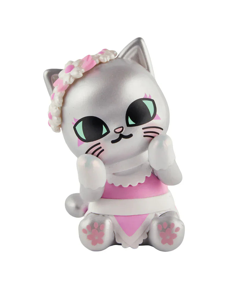 A silver cartoon cat with green eyes, pink and white dress, and a flower headband sits with paws raised—part of the Tokidoki Cherry Blossom Cats Single Blind Box collection by Tokidoki.