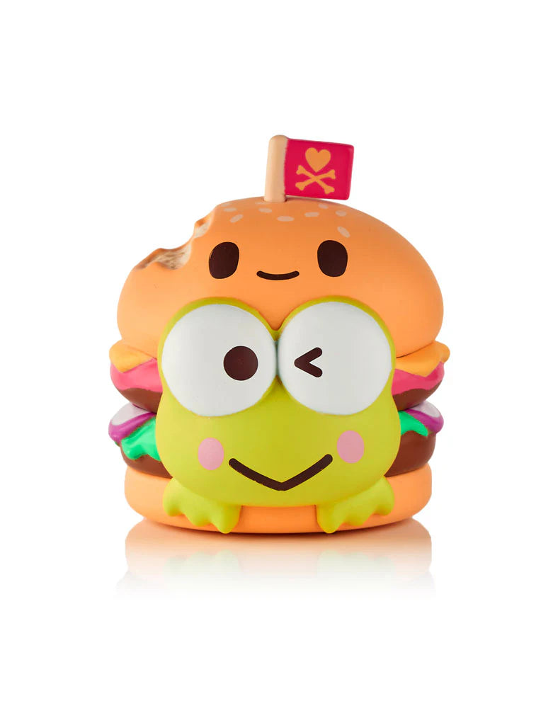 The Tokidoki x Hello Kitty & Friends Fast Food Blind Box by tokidoki (IT) features a cute hamburger toy with big eyes, a tiny flag, and vibrant colors—ideal for fans of collectible figures and blind box series.