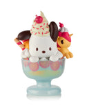 A cute dog character styled as an ice cream sundae with whipped cream, sprinkles, and a cherry sits in a glass dessert bowl next to a mini unicorn—part of the Tokidoki x Hello Kitty & Friends Fast Food Blind Box by tokidoki (IT), ideal for collectors.
