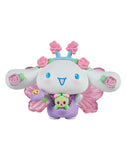 The Rotofugi Tokidoki x Hello Kitty and Friends Butterfly Garden - Cinnamoroll & Rosie Special Edition is a cute collectible featuring Cinnamoroll in a purple outfit with pink wings, a flower crown, and holding a bear-shaped accessory.