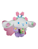 A cute white cartoon character with large ears, flower accents, pink wings, and a purple outfit holding a teddy bear—Tokidoki x Hello Kitty and Friends Butterfly Garden: Cinnamoroll & Rosie Special Edition by Rotofugi.