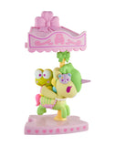 A pastel unicorn carousel figurine with a green frog under a pink, bow-adorned canopy—a delightful collectible from the tokidoki x Hello Kitty and Friends Sweet Pink Carousel Blind Box series by tokidoki.