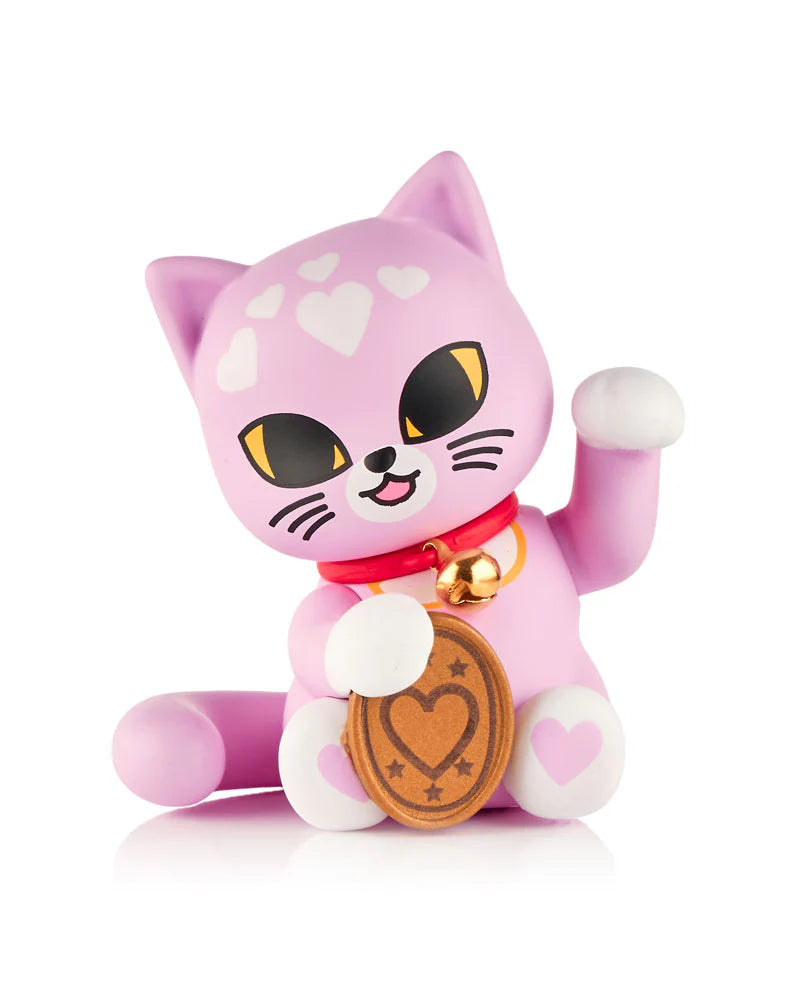 A pink tokidoki (IT) Lucky Cats Blind Box figurine featuring white heart markings, a red collar with gold bell, raised paw, and heart-coin—perfect for fans and collectors.