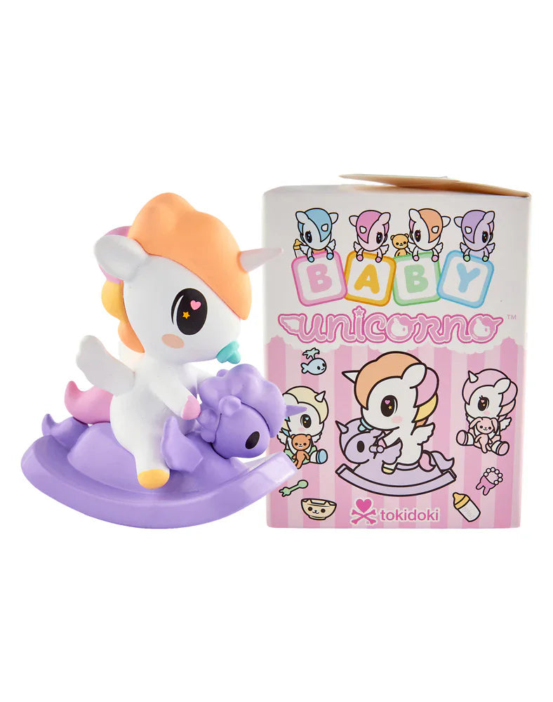 A tokidoki Baby Unicorno Blind Box figurine with an orange mane sits on a purple rocking horse beside its colorful box, perfect for tokidoki fans who love adorable collectibles and surprise unboxing.