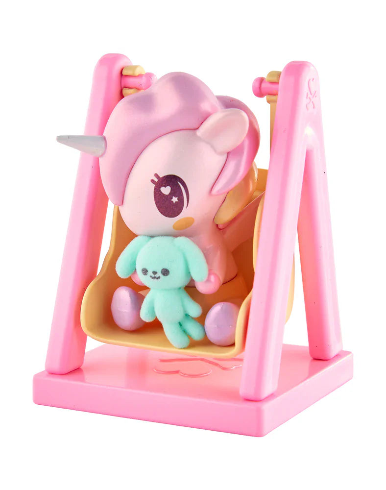 The tokidoki Baby Unicorno - Swingin' Baby Bunny (Special Edition) features a magical plush bunny on a yellow swing with a pink frame, adding charm and whimsy to any collection.