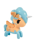 The Tokidoki Fortune Cookie Unicorno Blind Box features a small toy unicorn with blue hair, blue legs, orange body and wings, plus a white horn—an adorable surprise figure for any collection.