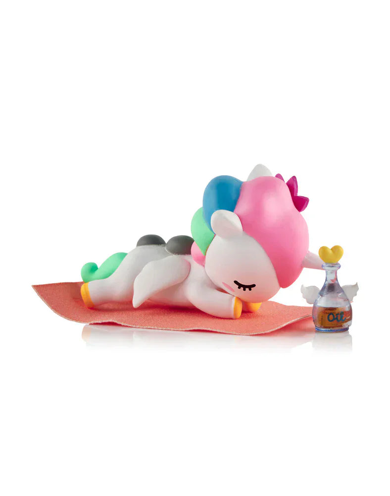 A Tokidoki Spa Day Unicorno from the Blind Box collection lounges peacefully on a cozy rug.